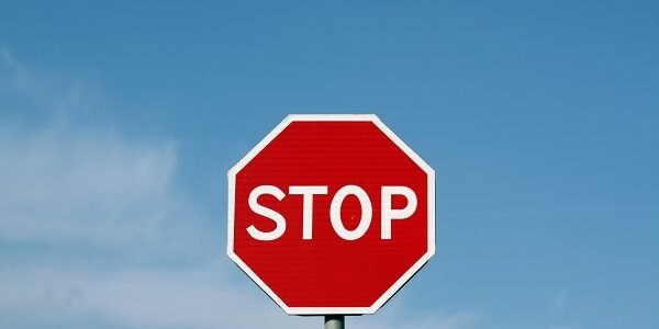 Stop sign against cloudy sky.