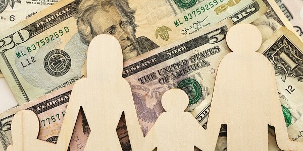 Business concept of family economy and expenses. Dollar bills and family sign