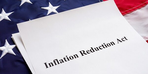 Papers with the Inflation Reduction Act and US flag.