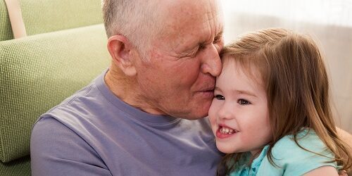 Grandpa kissing hia granddaughter